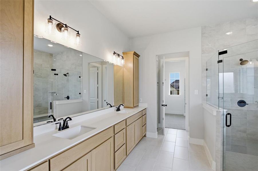 Full bathroom featuring double vanity, a shower stall, light tile patterned floors, and recessed lighting