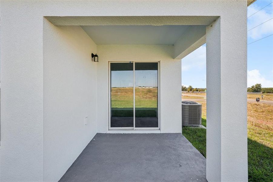Exterior details and patio area of a home in The Enclave at Scenic Terrace, Haines City (Image 7).