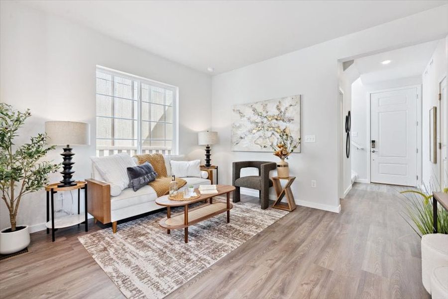 A living room with a rug and a coffee table. A living room with a rug and a coffee table.