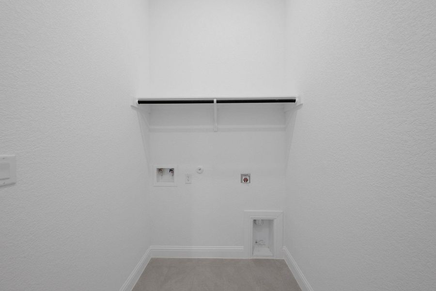 Laundry room featuring hookup for a gas dryer, electric dryer hookup, hookup for a washing machine, a textured wall, and light tile patterned floors