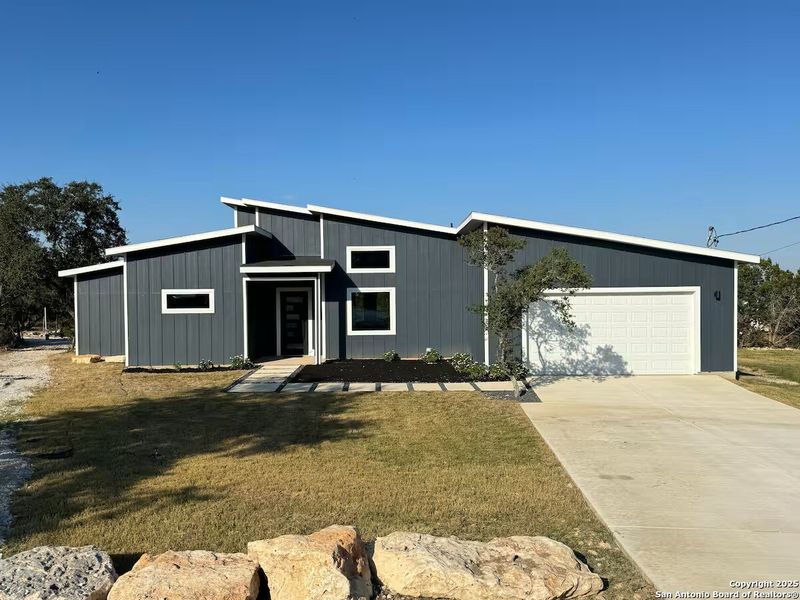 Front exterior of a new home in , Spring Branch, TX, highlighting curb appeal (Image 1). Front exterior of a new home in , Spring Branch, TX, highlighting curb appeal (Image 1).