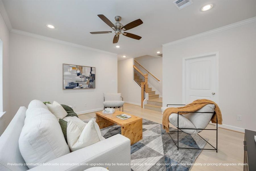 An alternate view of the game room shows a ceiling fan, access to the third level, and a journey down to the laundry room, defining multifunctional luxury.