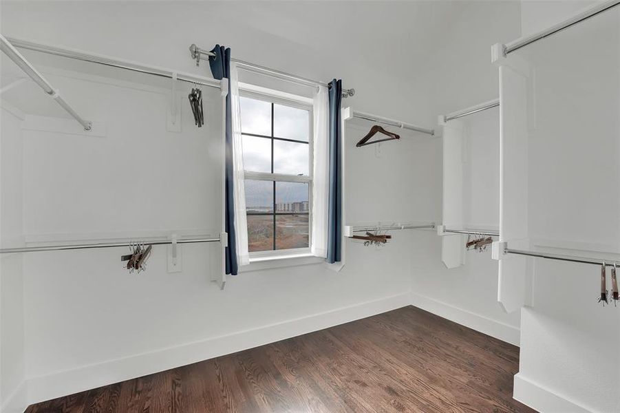 Walk in closet featuring dark wood finished floors