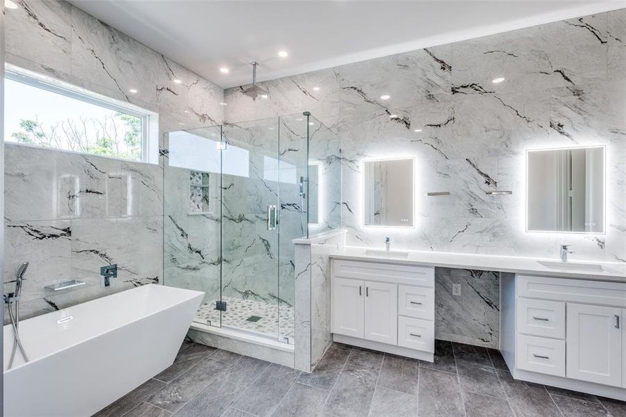 Bathroom with tile walls, independent shower and bath, and vanity