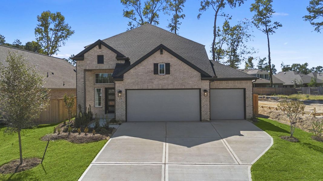 Front exterior of a new home in The Woodlands Hills, Willis, TX, highlighting curb appeal (Image 17). Front exterior of a new home in The Woodlands Hills, Willis, TX, highlighting curb appeal (Image 17).