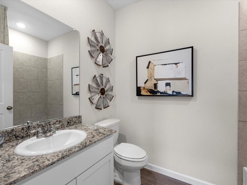 A bathroom with a mirror and sink. A bathroom with a mirror and sink.