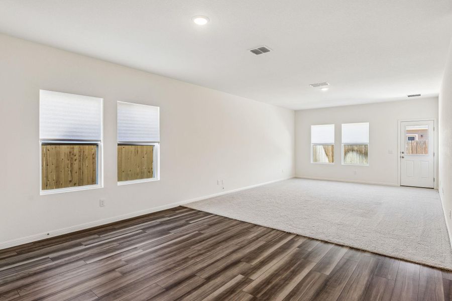 Empty room with baseboards and dark wood-type flooring