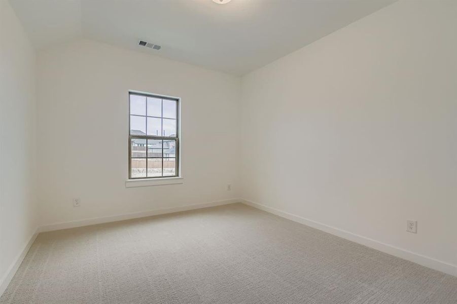 Empty room featuring light carpet and baseboards Empty room featuring light carpet and baseboards