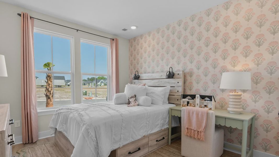 First-floor secondary bedroom in the Summit home plan with comfort and natural light.