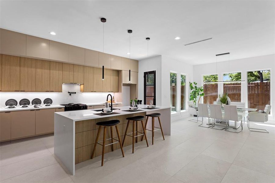 Kitchen featuring sink, range with gas cooktop, a healthy amount of sunlight, and light tile patterned floors