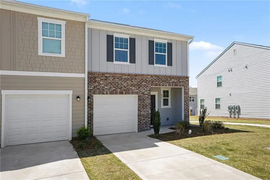 Front exterior of a new home in , Locust Grove, GA, highlighting curb appeal (Image 23).