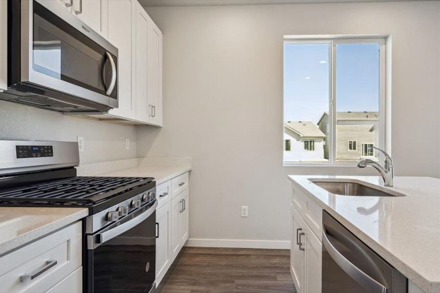 A kitchen with white cabinets. A kitchen with white cabinets.