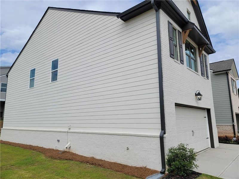 Front exterior of a new home in Kentmere, Auburn, GA, highlighting curb appeal (Image 16).
