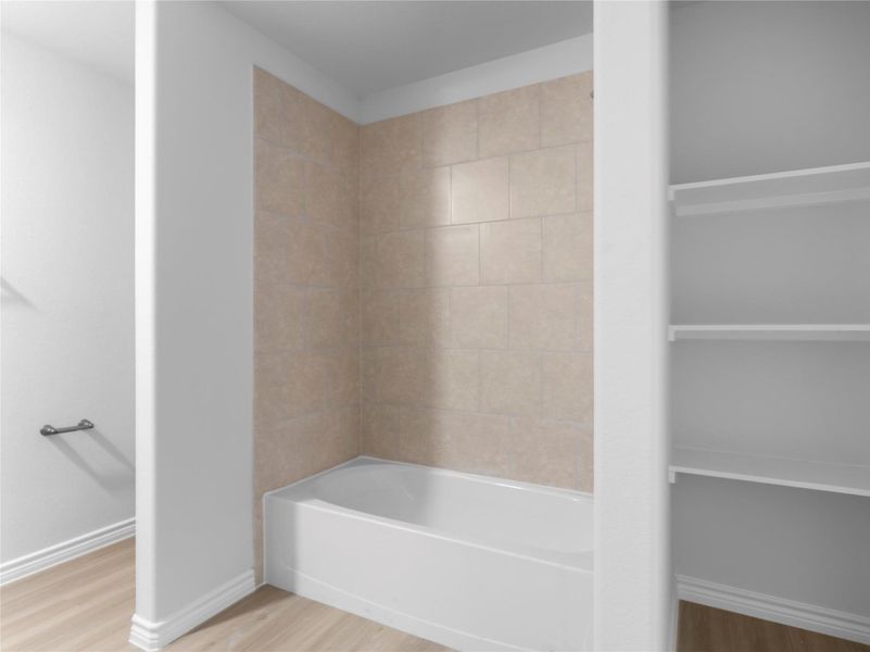 Elegant upstairs master bathroom with convenient built-in shelving.