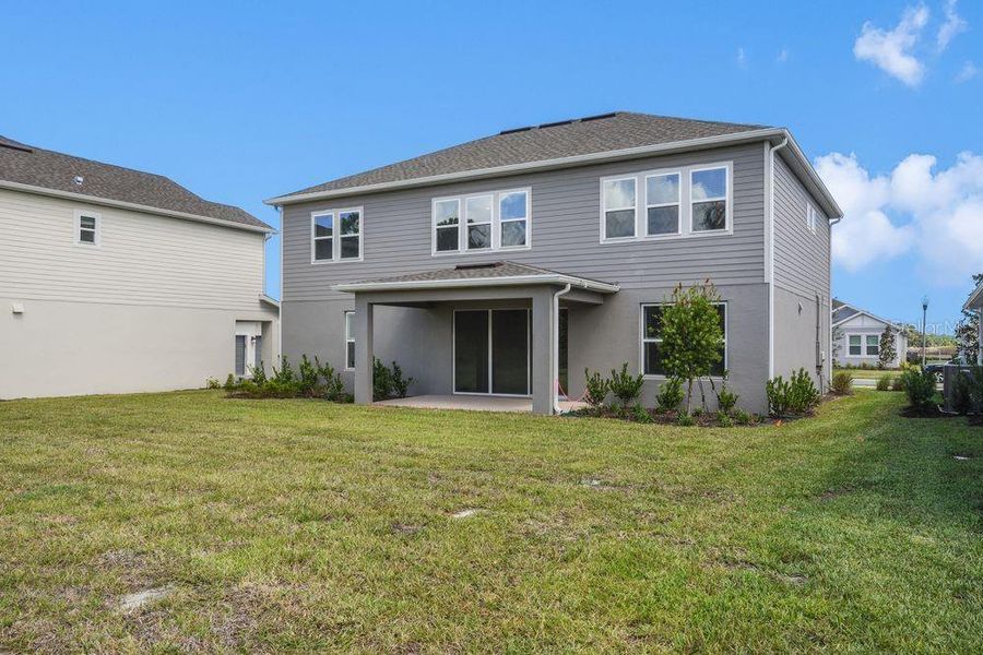 Exterior details and patio area of a home in Ardisia Park, New Smyrna Beach (Image 4).