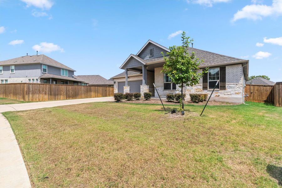 View of front facade with driveway, a garage, brick siding, and stone siding View of front facade with driveway, a garage, brick siding, and stone siding