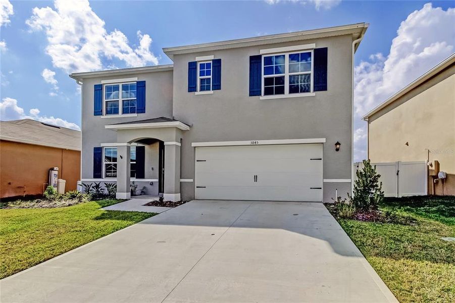 Front exterior of a new home in Lakes at Laurel Highlands, Lakeland, FL, highlighting curb appeal (Image 28).