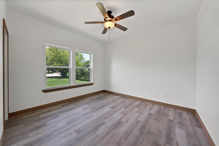 Spare room featuring light wood-style flooring and ceiling fan
