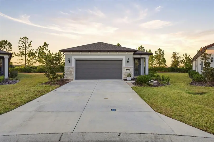 Front exterior of a new home in Del Webb Stone Creek, Ocala, FL, highlighting curb appeal (Image 1). Front exterior of a new home in Del Webb Stone Creek, Ocala, FL, highlighting curb appeal (Image 1).