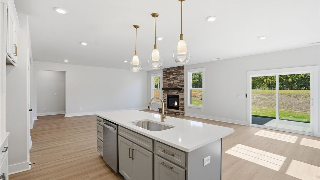 Accomplished kitchen design featuring pendant lighting above a statement island for both prep and gathering in Woodruff, SC Accomplished kitchen design featuring pendant lighting above a statement island for both prep and gathering in Woodruff, SC