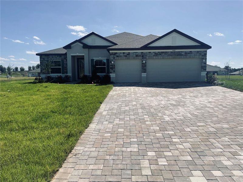 Front exterior of a new home in Graceland Estates, Thonotosassa, FL, highlighting curb appeal (Image 1). Front exterior of a new home in Graceland Estates, Thonotosassa, FL, highlighting curb appeal (Image 1).