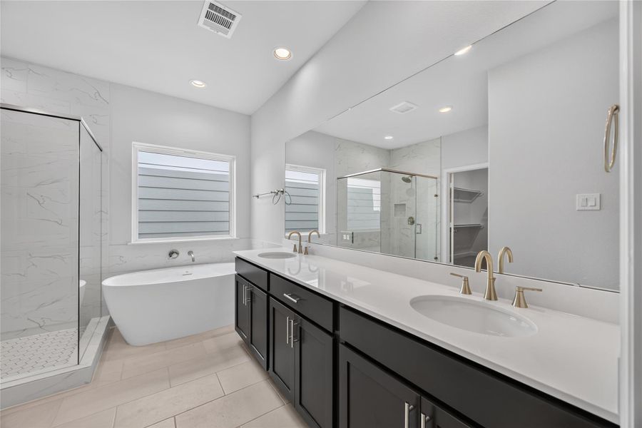 Freestanding Soaking Tub – The centerpiece of the primary bathroom, this freestanding soaking tub invites you to unwind in a spa-like setting with its sleek design and tranquil ambiance. Experience luxury in the glass-enclosed walk-in shower, featuring elegant tile and premium fixtures for a serene start or end to your day.