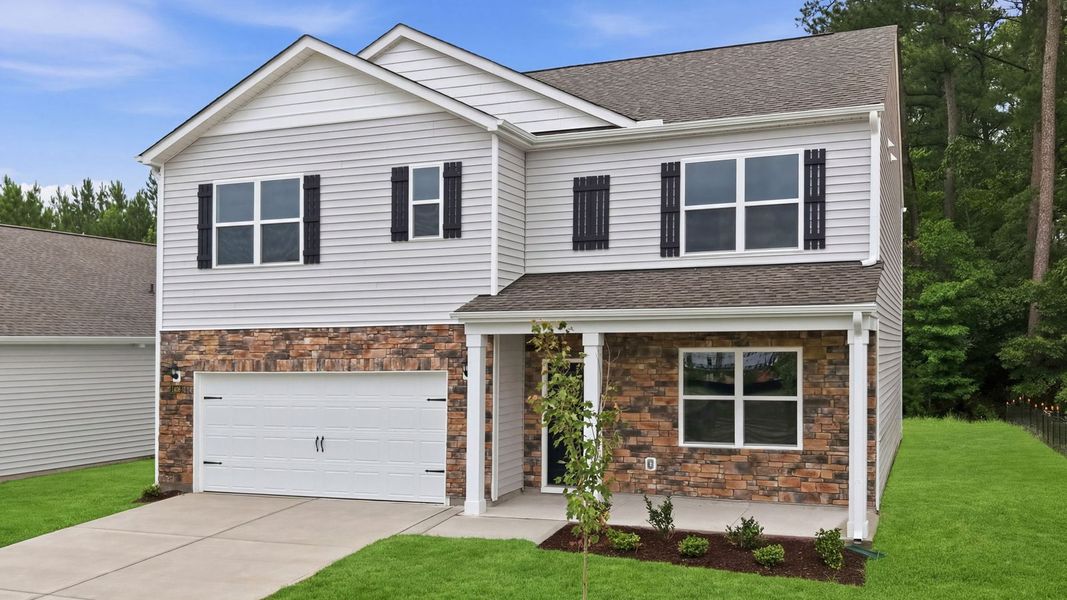 Front exterior of a new home in Ridgewood Farms, Winterville, NC, highlighting curb appeal (Image 22). Front exterior of a new home in Ridgewood Farms, Winterville, NC, highlighting curb appeal (Image 22).