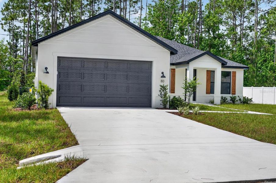 Front exterior of a new home in , Palm Coast, FL, highlighting curb appeal (Image 24). Front exterior of a new home in , Palm Coast, FL, highlighting curb appeal (Image 24).