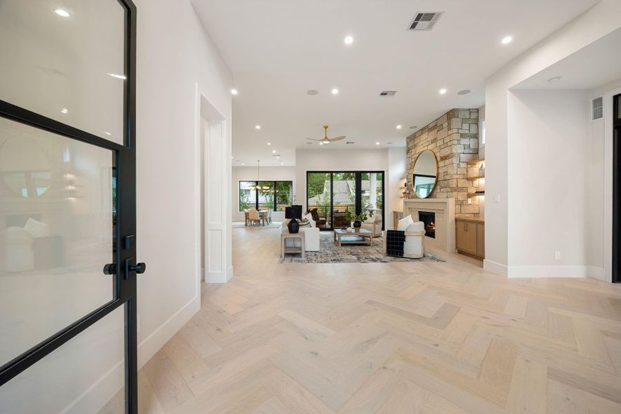 An expansive living and dining area designed for effortless gathering, where natural light floods through large sliding glass doors that open to the outdoor living space. The open layout creates a seamless connection between indoors and out, while clean lines and soft, neutral finishes offer a timeless backdrop. Every detail feels intentional, creating a space that’s both inviting and refined for everyday living or entertaining.