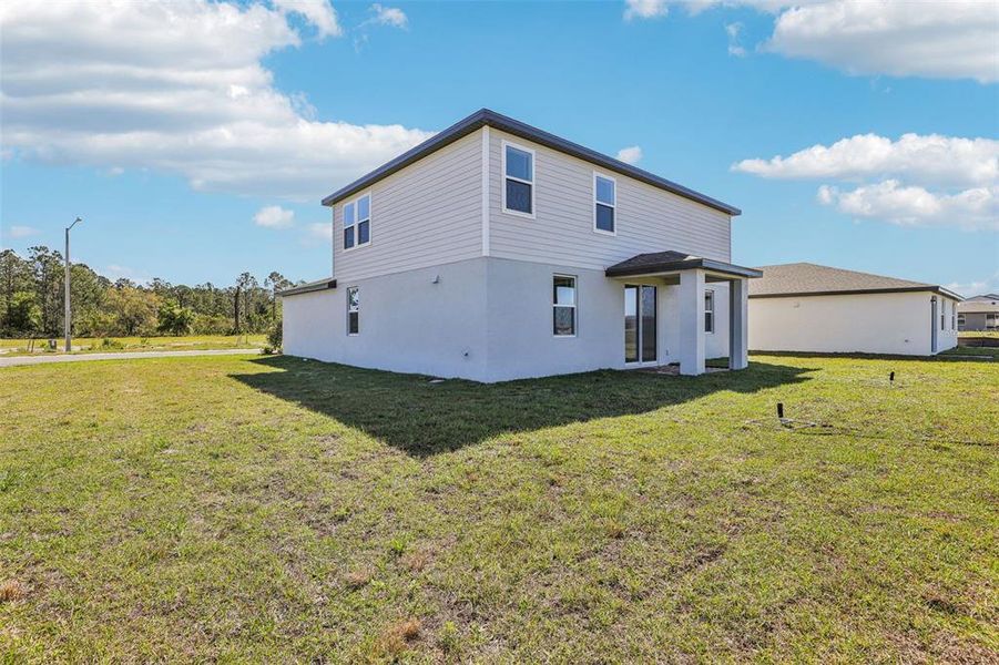 Exterior details and patio area of a home in Lake Deer Estates - Signature Series, Poinciana (Image 3). Exterior details and patio area of a home in Lake Deer Estates - Signature Series, Poinciana (Image 3).