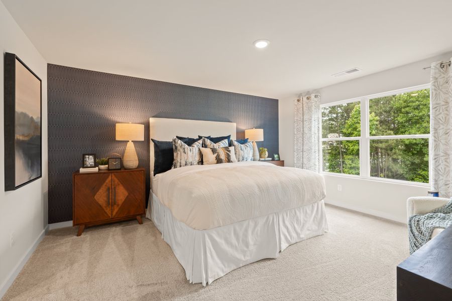 A bedroom with a bed and a window. A bedroom with a bed and a window.