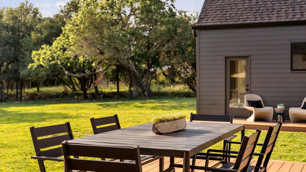 An inviting outdoor dining area awaits on a spacious deck, perfect for alfresco gatherings amidst a verdant landscape. An inviting outdoor dining area awaits on a spacious deck, perfect for alfresco gatherings amidst a verdant landscape.