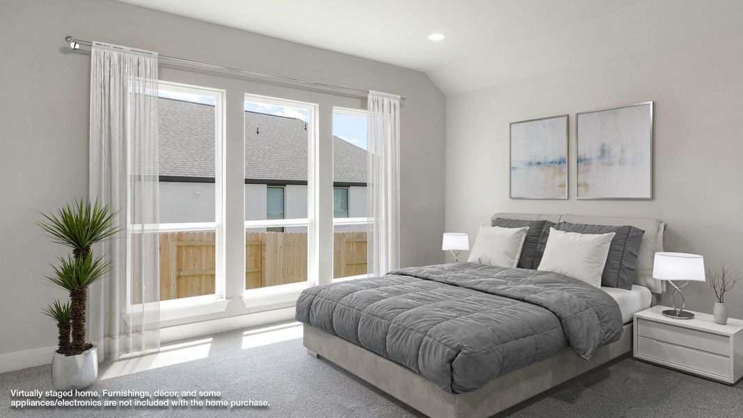 Bedroom featuring lofted ceiling and dark carpet
