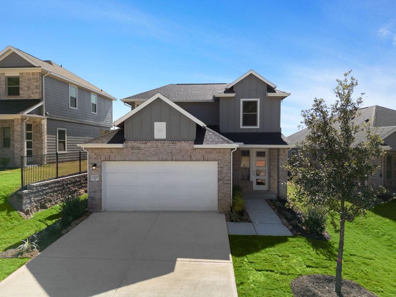 Front exterior of a new home in Westridge Cove, Conroe, TX, highlighting curb appeal (Image 1).