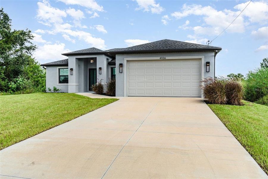 Front exterior of a new home in , Lehigh Acres, FL, highlighting curb appeal (Image 24).