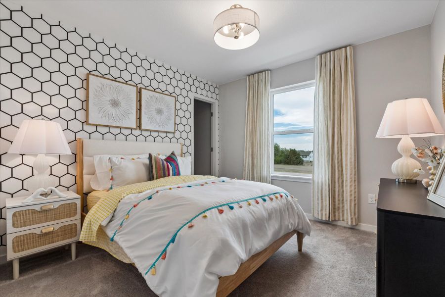 A bedroom with a bed and a window. A bedroom with a bed and a window.