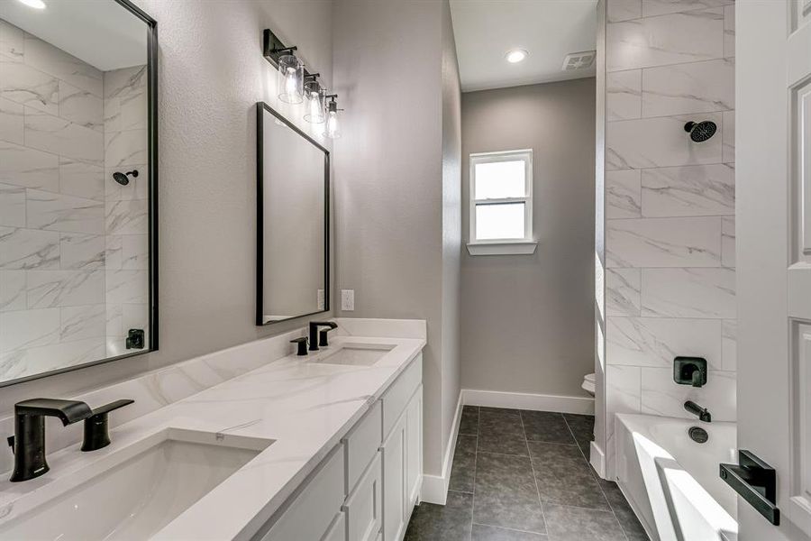 Full bathroom featuring tile patterned floors, toilet, vanity, and plus walk in shower