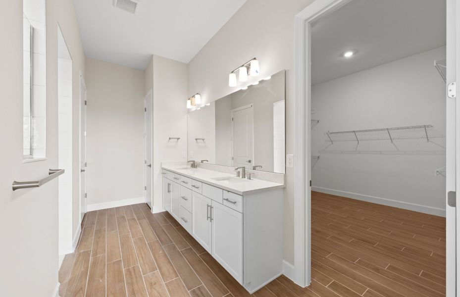 Owner's bathroom with dual-sink vanity and spacious shower