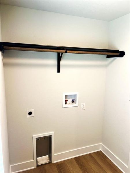 Laundry area featuring hookup for a washing machine, hookup for an electric dryer, dark wood-type flooring, and baseboards Laundry area featuring hookup for a washing machine, hookup for an electric dryer, dark wood-type flooring, and baseboards