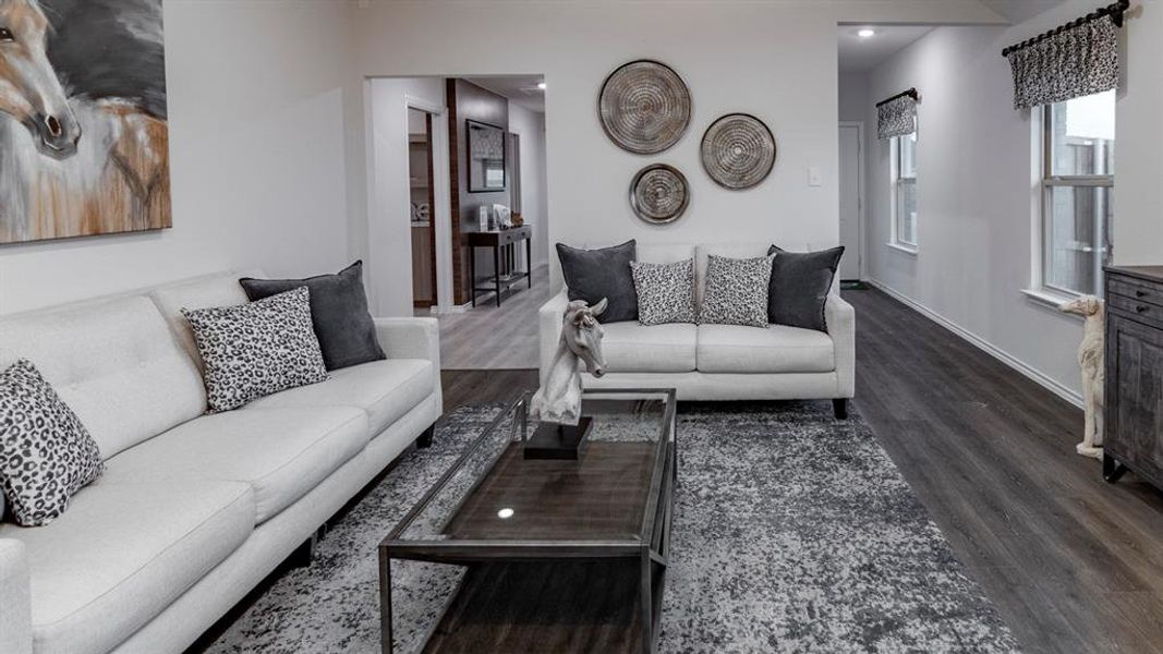 Living room with dark wood-type flooring and recessed lighting