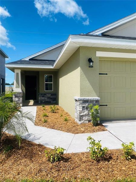Front exterior of a new home in , St. Cloud, FL, highlighting curb appeal (Image 13).