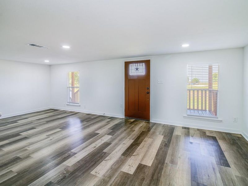 Entryway featuring healthy amount of natural light, wood finished floors, and recessed lighting Entryway featuring healthy amount of natural light, wood finished floors, and recessed lighting