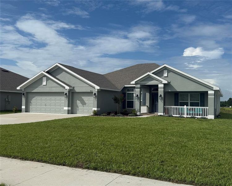 Front exterior of a new home in Cadence Crossing, Auburndale, FL, highlighting curb appeal (Image 20).