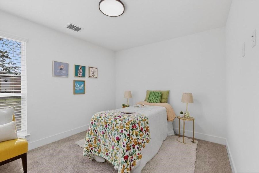 Bedroom featuring carpet floors and baseboards Bedroom featuring carpet floors and baseboards