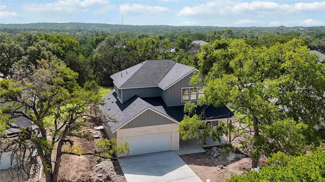 Front exterior of a new home in , Wimberley, TX, highlighting curb appeal (Image 1).