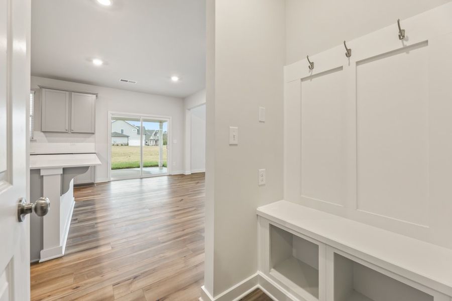 A white kitchen with a wood floor. A white kitchen with a wood floor.