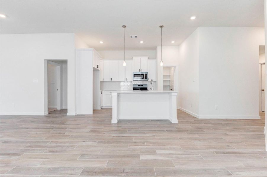 The chef-inspired kitchen stuns with its clean white palette, quartz countertops, stylish subway tile backsplash, and abundant cabinetry. A deep stainless steel sink, gas range, and built-in microwave make this kitchen a dream for cooking, hosting, or casual dining. The chef-inspired kitchen stuns with its clean white palette, quartz countertops, stylish subway tile backsplash, and abundant cabinetry. A deep stainless steel sink, gas range, and built-in microwave make this kitchen a dream for cooking, hosting, or casual dining.