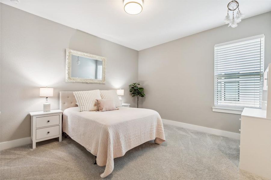 Bedroom featuring light colored carpet