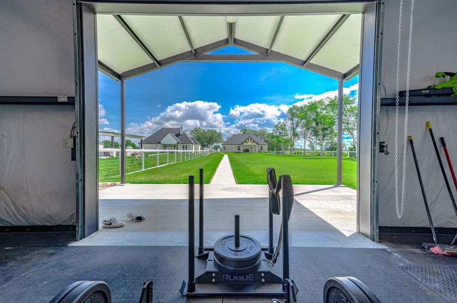 This spacious garage and flex area offers plenty of room for storage, hobbies, equipment, or recreational use, all while overlooking the beautifully maintained backyard and surrounding outdoor space.