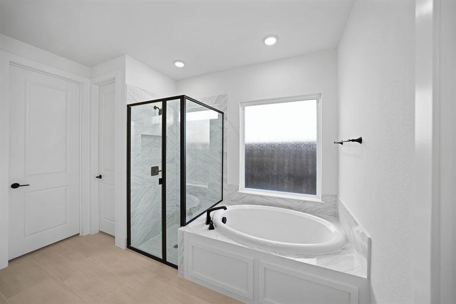 Bathroom with a garden tub, a marble finish shower, and recessed lighting Bathroom with a garden tub, a marble finish shower, and recessed lighting